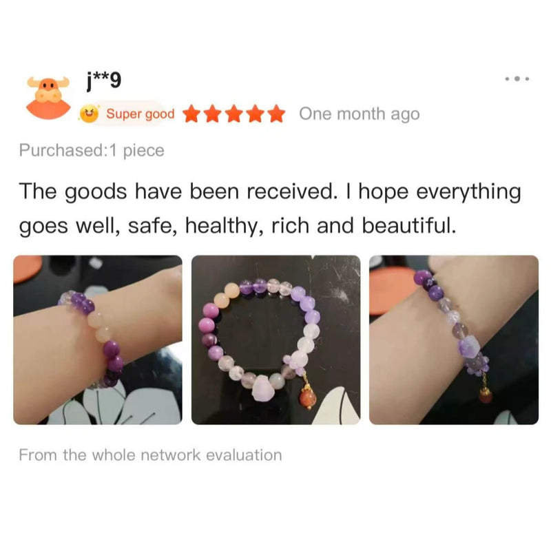 Handcrafted natural purple and pink crystal bead bracelet on a wrist.