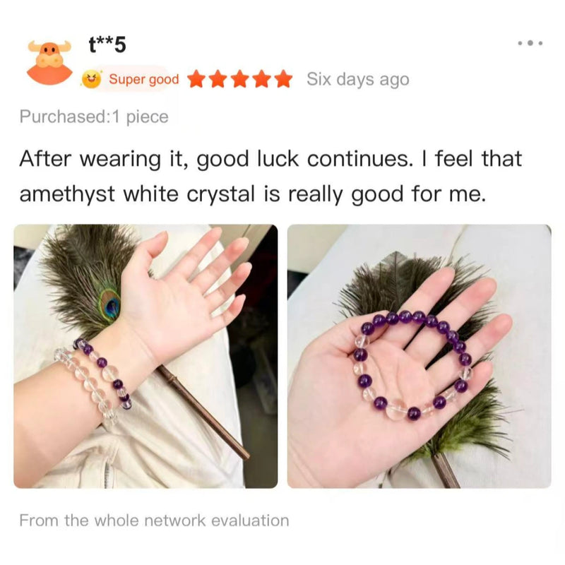 Hand wearing amethyst and white crystal beaded bracelets with a peacock feather background.