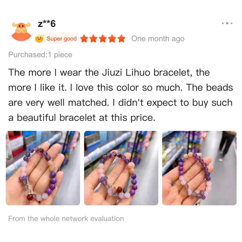 Handheld multi-colored natural gemstone crystal bead bracelet in shades of purple, pink, and red.