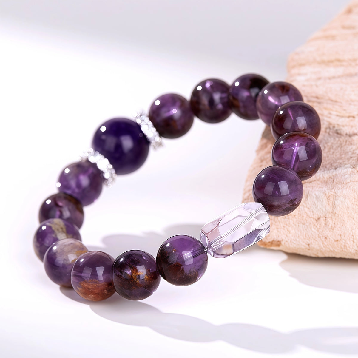 Handcrafted purple amethyst crystal bead bracelet with a clear quartz focal charm.